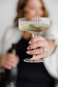 Close-up of planner offering a champagne toast, celebrating joy-filled wedding planning with The Eventful Gals in Northeast Florida.