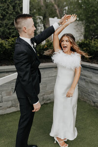 A bride and groom twirling and dancing together during a wedding event