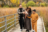 Greater Toronto Family Photography session at Kerncliff Park standing on a bridge during Autumn.