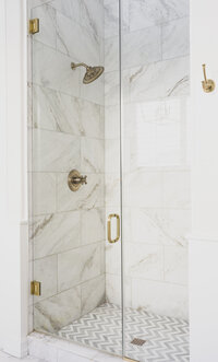Gold and white bathroom shower