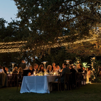 An outdoor wedding reception in Dallas with string lights overhead