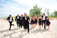A fun wedding party photo taken at a Lake Michigan beach.