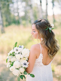 bride looking to the side while holding wedding boquet