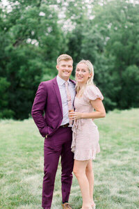milwaukee event planners, Molly, poses with her husband in a grassy area.