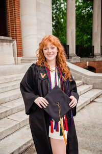 Girl wearing Vanderbilt robe standing on steps of Wyatt Center