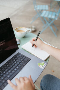 Woman writing in her notebook for a guest blogging opportunity for SEO | The Comma Mama Co.