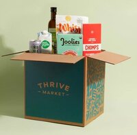 a thrive market carbboard box with groceries coming out