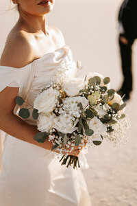 Bonneville Salt Flats Elopement with bride and groom and florals