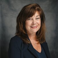 Gina smiling above testimonial she gave for Chapter tOO
