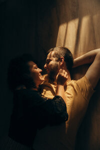 Couple lying together laughing during a relaxed session with a Sunshine Coast photographer