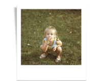 Annie as a 3 year old crouched with a cigar