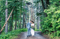 Newlyweds standing together at Pinewood Weddings & Events touching heads at they stay in the romantic moment.