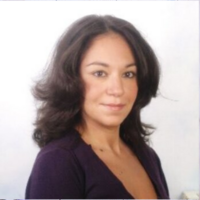 Valeria posing professionally in a dark blouse