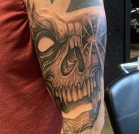 Bold, detailed tattoo on the upper arm by top Tacoma tattoo artist at The Dark Art Collective