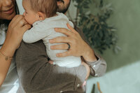 couple holding baby during NYC newborn session by Elsie Goodman Photography