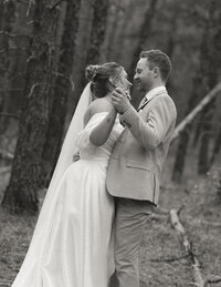 bride and groom dancing in the woods
