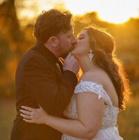 a newlywed couple kissing 