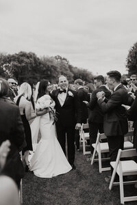 A couple walking back down the aisle together after just getting married