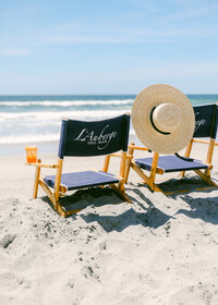 chairs on beach overlooking ocean luxury hotel photographer with french market hat in california