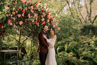 bride and groom by flowers