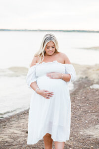mama to be holds stomach during dallas tx maternity session with mckinney maternity photographer