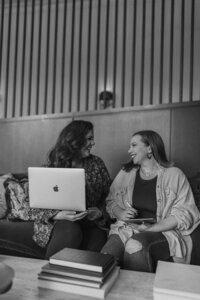 black and white image women sitting on couch