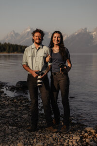 Wyoming elopement photographer and videographer standing at Colter Bay in Grand Teton National Park