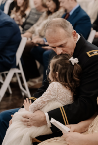Grandpa in Uniform Kissing Grandchild