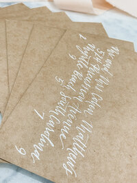 white ink envelope addressed in modern calligraphy