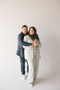 A man and woman videography team pose together, smiling and enjoying the moment.