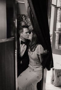 bride and groom in photo booth kissing