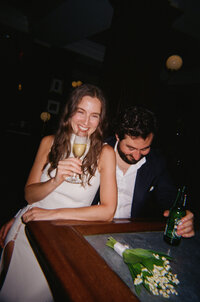 bride and groom drinking and laughing