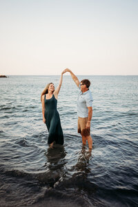 couples beach photo in gloucester dancing in the water