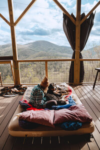 woman sitting on deck with dog