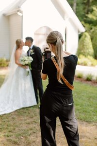 photographer taking a photo of a couple at their wedding at the chapel at firefly lane in tennessee