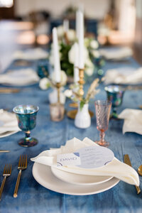 A blue and white themed wedding table scape in the The French Farmhouse Venue in Collinsville, Texas.
