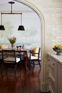 A Boston kitchen designer creates a luxury space in a Milton home with white kitchen cabinets, vintage furniture, and classic style for a traditional home.