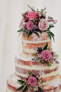 Sponge wedding cake with icing and fresh flower decoration