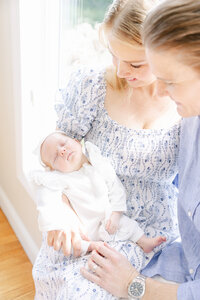 newborn Baby snuggling in mother's arms