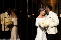 Bridal Portrait the Groom is kissing his Bride on the forehead as she hold her lush bouquet of roses and peonies at the Whitley Hotel Atlanta event design Tined Events Design and Planning