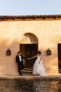 bride and groom hold hands after wedding in phoenix