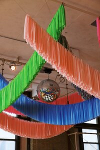 A bok weding with colorful ceiling streamers and a disco ball