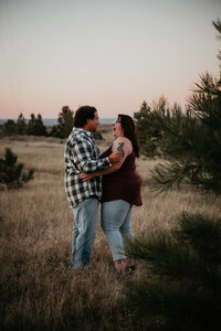 Engagement photo session in South Dakota, showcasing a couple sharing a romantic moment in a scenic outdoor setting, with natural landscapes and intimate connection.
