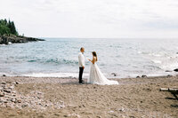 Bride and groom saying marriage vows in private of lake Superior on the North Shore in Minnesota | North Shore wedding photographer