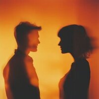 Silhouetted couple facing each other in warm light, symbolizing vulnerability, reflection, and emotional healing after infidelity.