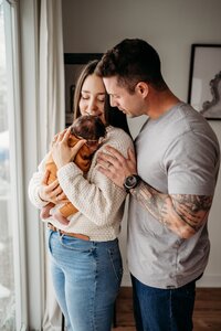 Mom and dad holding newborn baby