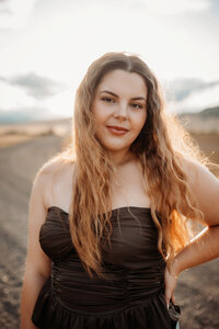 Senior Photography, girl posing in black dress on a cloudy day