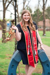 Chi Omega senior standing on blue horseshoe at MTSU