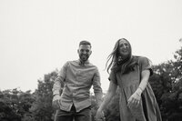 Black and white photo of couple walking and laughing