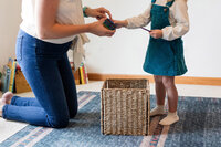 Toddler playing with their mother